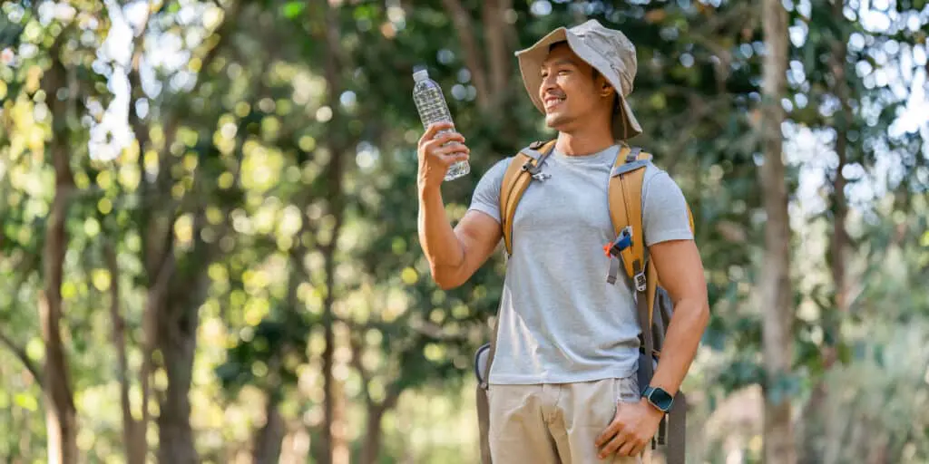 Stay Hydrated: Tips for Summer Wellness 1 young man backpacker traveling alone in forest at 2024 03 20 15 03 27 utc scaled