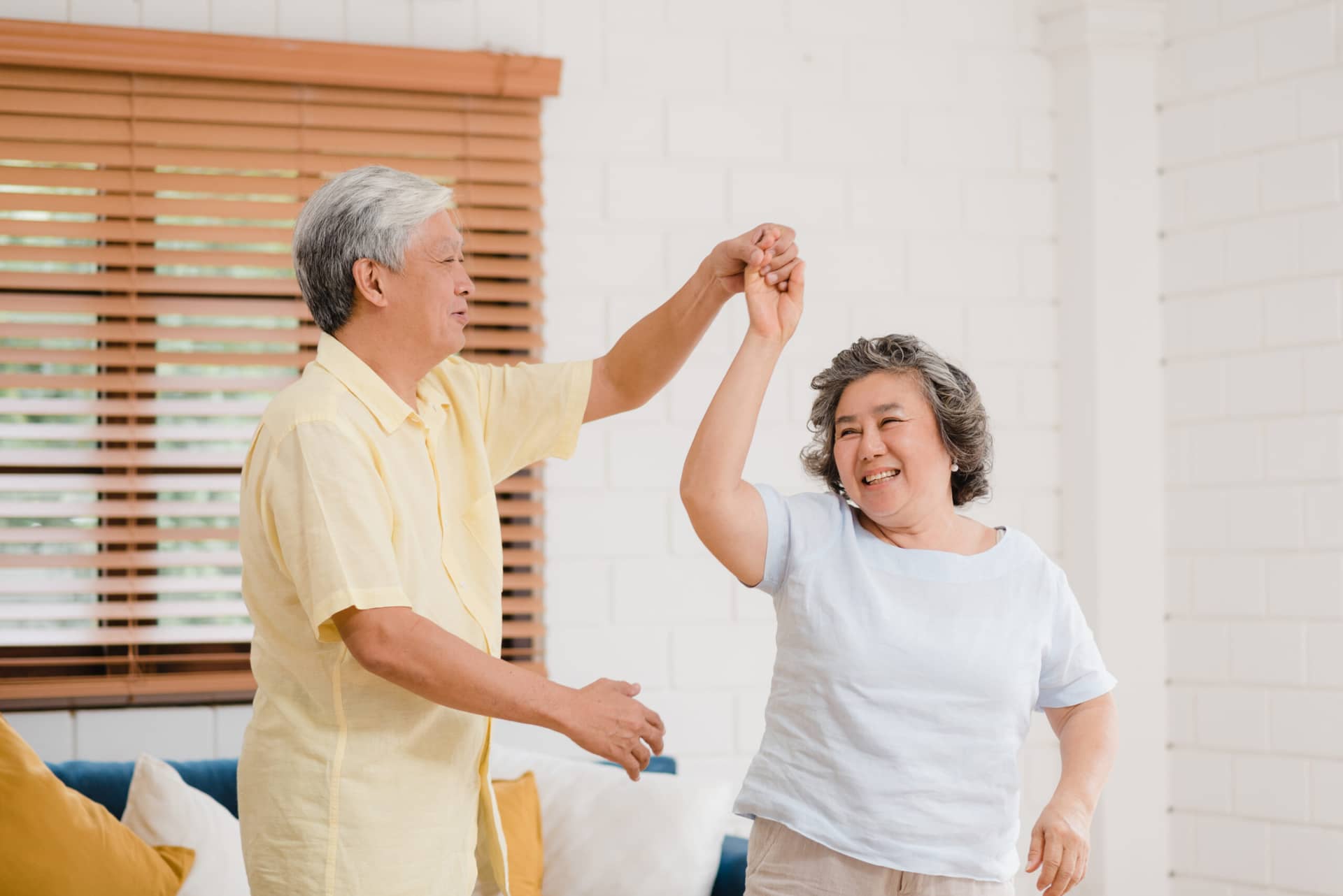 asian elderly couple dancing together while listen music living room home sweet couple enjoy love moment while having fun when relaxed home scaled